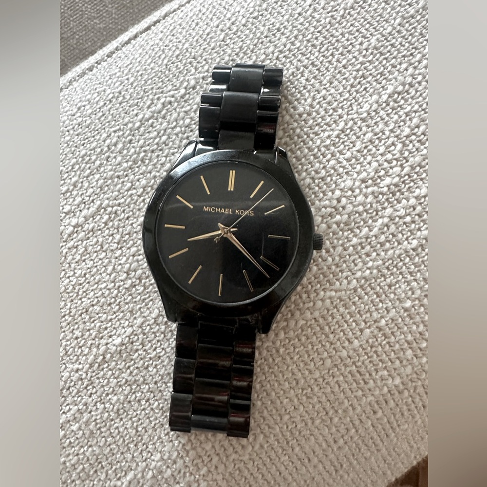 Michael Kors Black watch with gold hands.